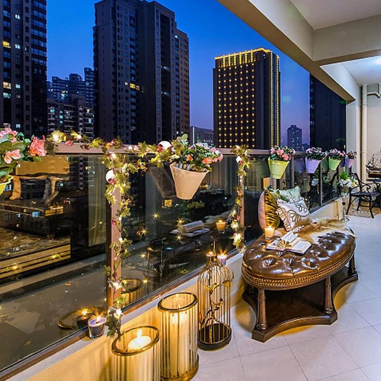 Vanity mirror frame adorned with artificial rose garland fairy lights creating magical reflection