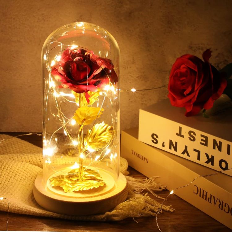 Luxurious 24K gold plated eternal rose preserved in crystal glass dome with warm LED illumination on wood base