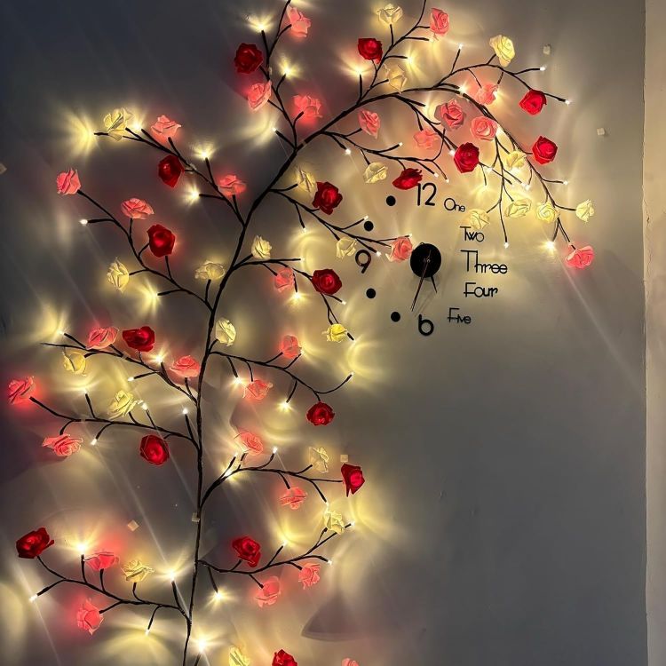 Bedroom wall beautifully decorated with rose blossom branch vine lights creating cozy romantic ambiance