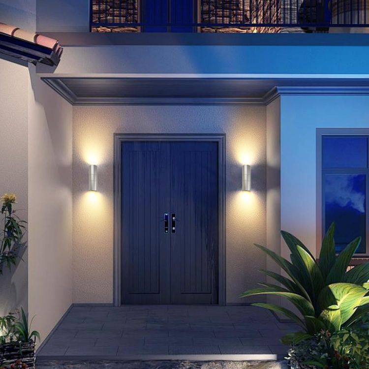 Motion sensor wall lights illuminating porch entrance