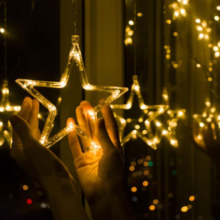 Picture of Christmas LED Stars Curtain Lights,12 Stars 138 Window Curtain String Lights with 8 Flashing Modes Decoration for Wedding, Party,Wall, Home Decorations,USB/Battery Powered (Warm White)